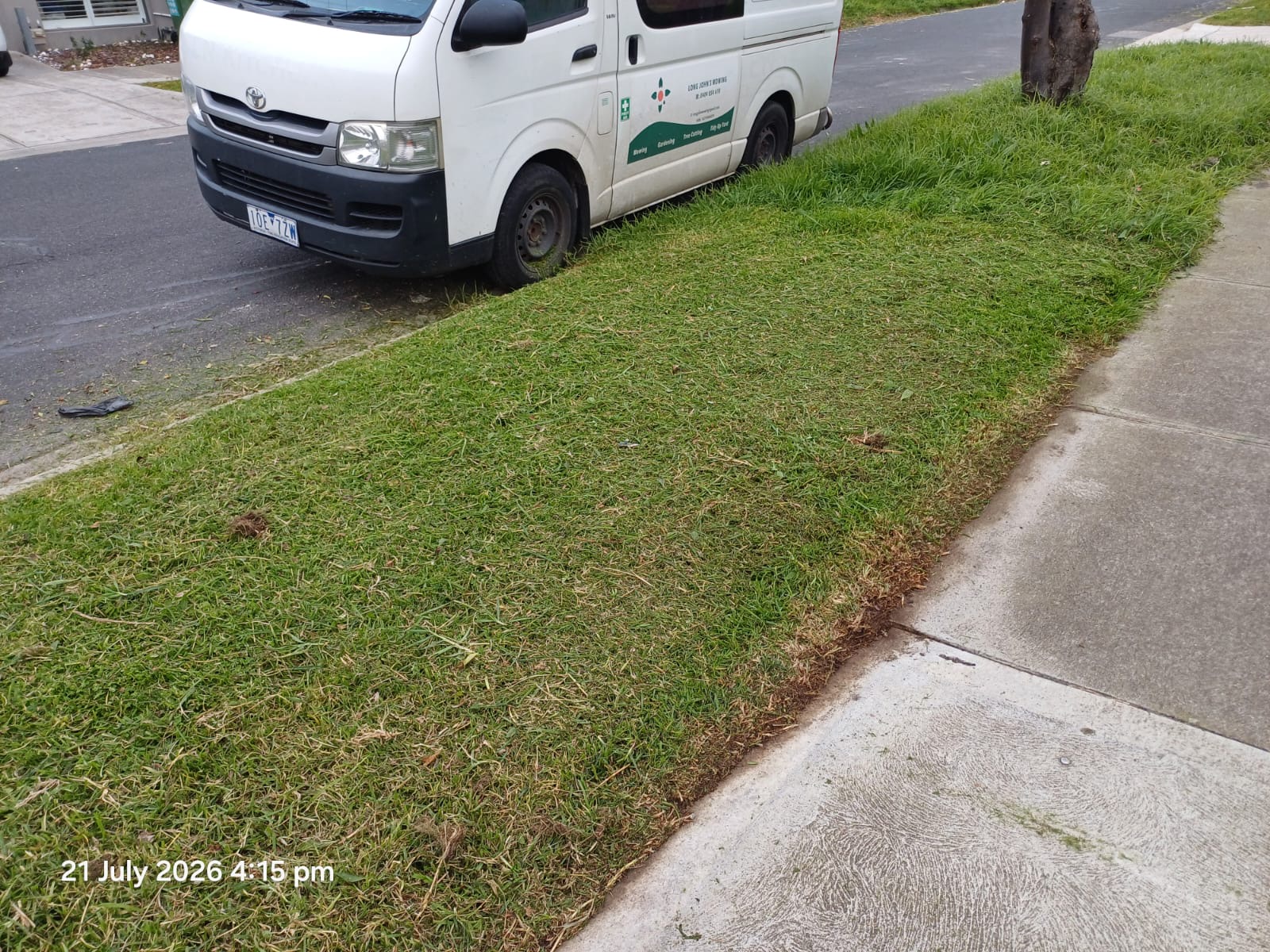 Long John's Mowing and Gardening Service service van beside a freshly mowed nature strip